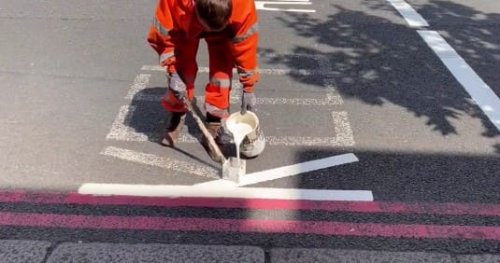 Un operaio mentre realizza della segnaletica orizzontale.