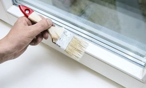 La verniciatura di una finestra in alluminio, dopo la fase di carteggiatura